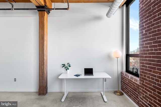 office featuring brick wall and plenty of natural light