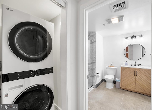 clothes washing area with stacked washer and dryer and sink