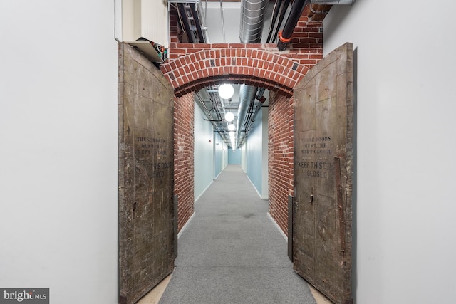 hallway with brick wall