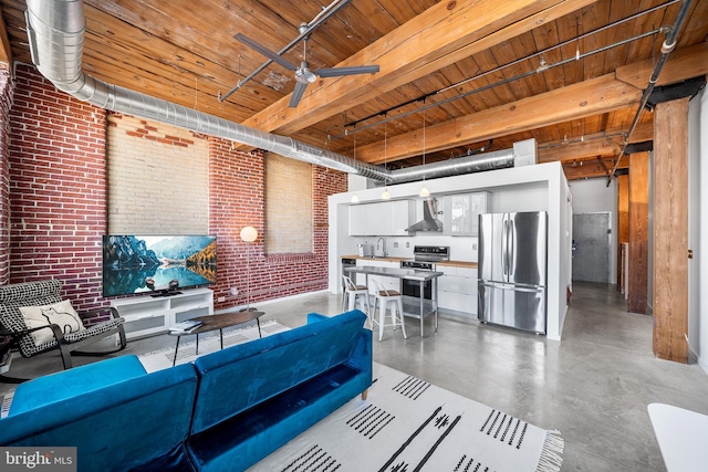 living room featuring brick wall, wood ceiling, beam ceiling, concrete flooring, and ceiling fan