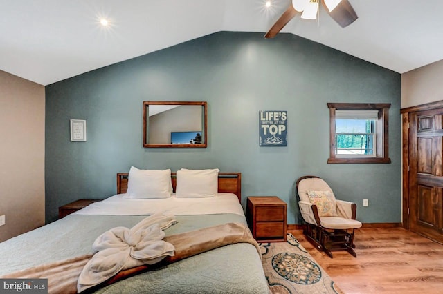 bedroom with ceiling fan, light hardwood / wood-style flooring, and vaulted ceiling