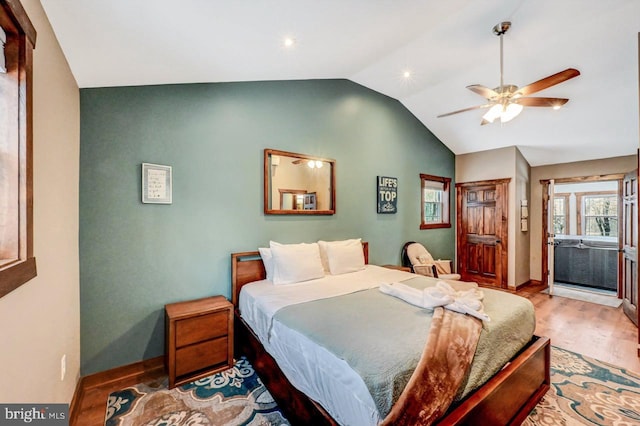 bedroom featuring ceiling fan, hardwood / wood-style floors, and lofted ceiling