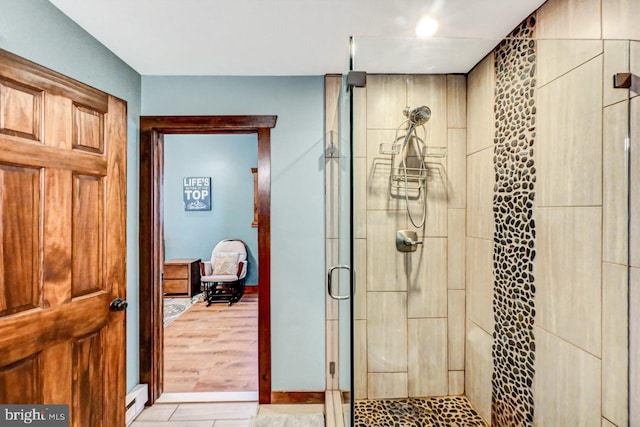 bathroom featuring wood-type flooring and an enclosed shower