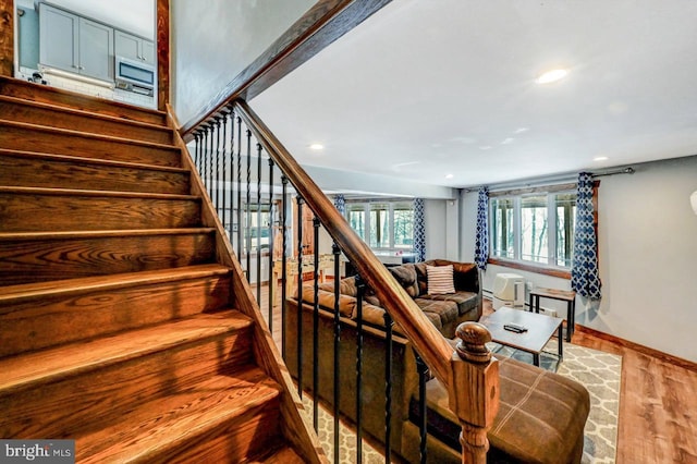 stairs with hardwood / wood-style floors