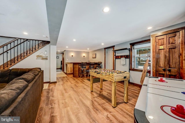 playroom featuring bar and light hardwood / wood-style floors