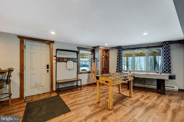 dining area featuring baseboard heating and light hardwood / wood-style flooring