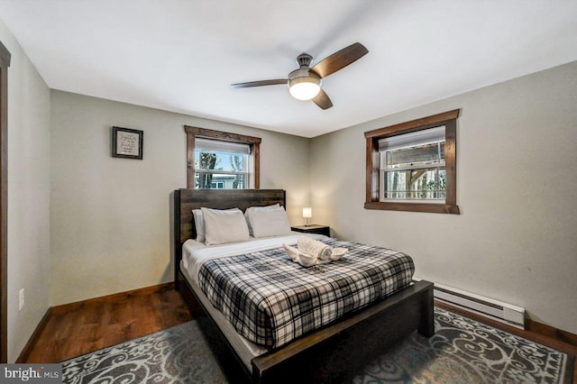 bedroom featuring ceiling fan, baseboard heating, and dark hardwood / wood-style flooring