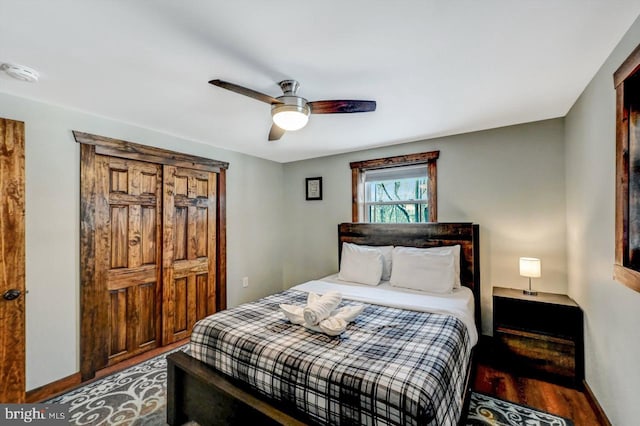 bedroom with ceiling fan and wood-type flooring