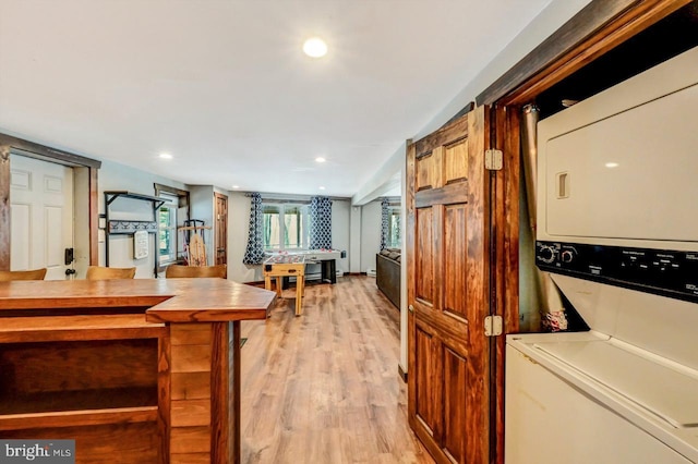 kitchen featuring stacked washer and dryer and light hardwood / wood-style flooring