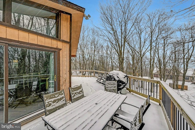 snow covered deck with grilling area