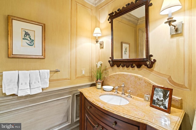 bathroom with crown molding and vanity