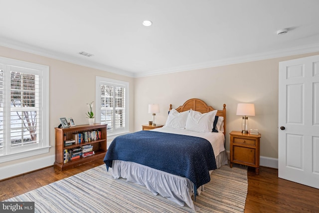 bedroom featuring dark wood-type flooring, multiple windows, and crown molding