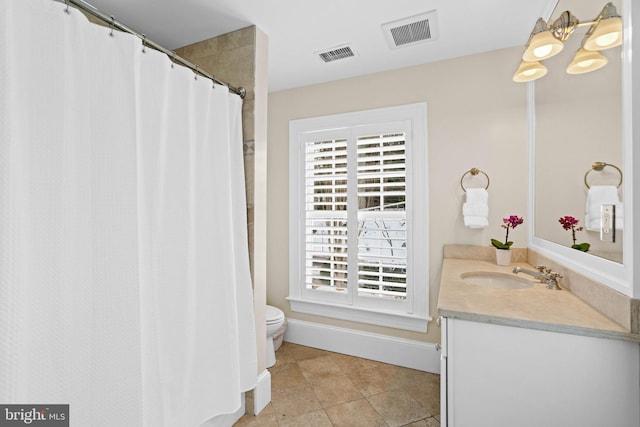 bathroom with toilet, tile patterned floors, and vanity