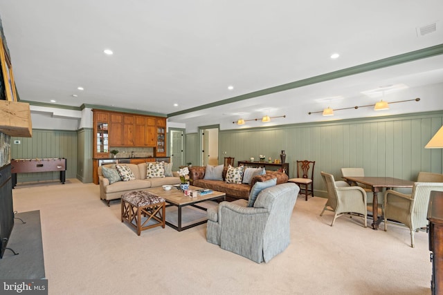 living room with ornamental molding and light colored carpet