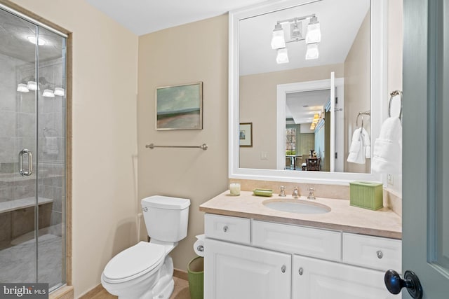 bathroom featuring walk in shower, vanity, and toilet