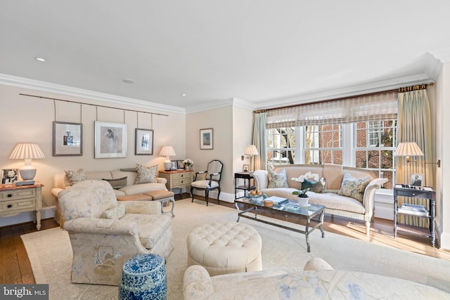 living room with hardwood / wood-style floors and crown molding