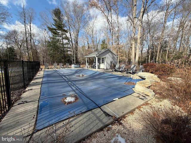 view of swimming pool featuring an outdoor structure and a patio area