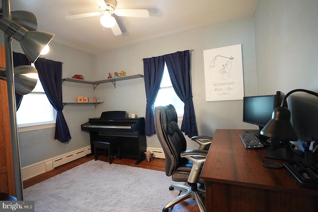 office space featuring baseboard heating and ceiling fan