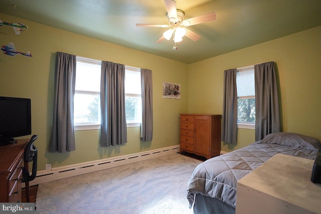 carpeted bedroom featuring multiple windows, a baseboard radiator, and ceiling fan