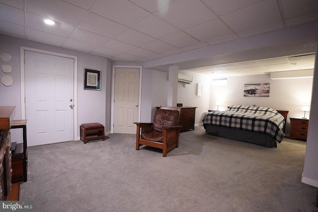 carpeted bedroom featuring a drop ceiling