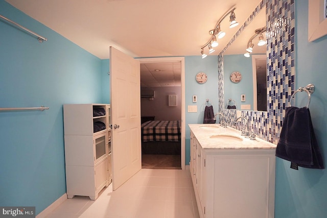 bathroom featuring vanity, tile patterned flooring, decorative backsplash, and track lighting