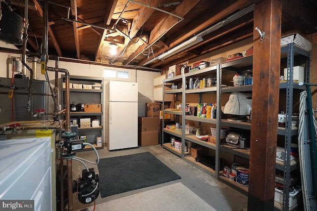 basement featuring white refrigerator