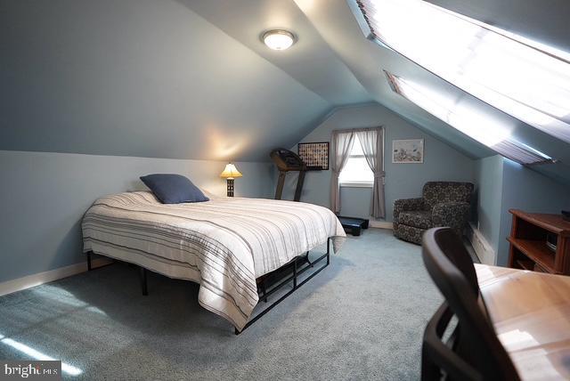 carpeted bedroom with vaulted ceiling