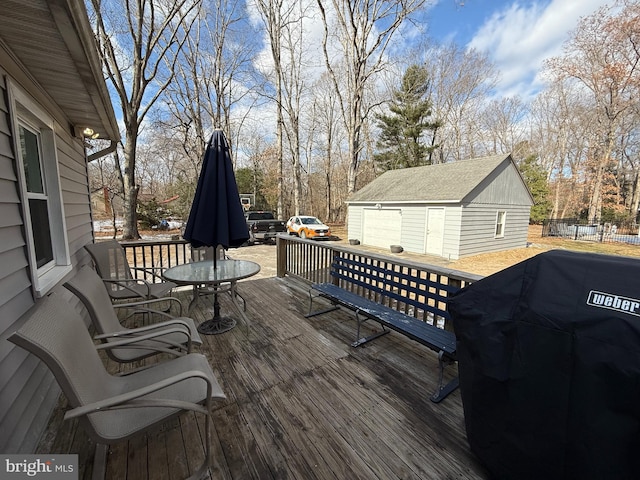 wooden terrace featuring area for grilling and a storage unit