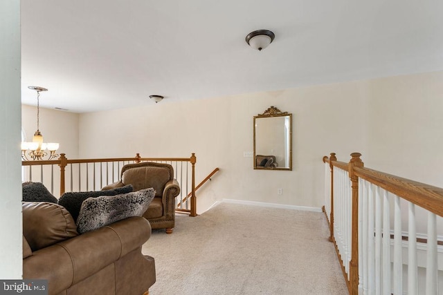 sitting room featuring light colored carpet and an inviting chandelier