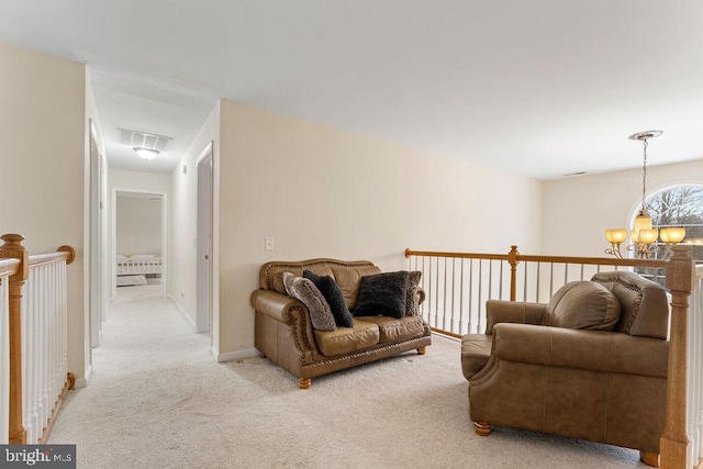 carpeted living room featuring a notable chandelier