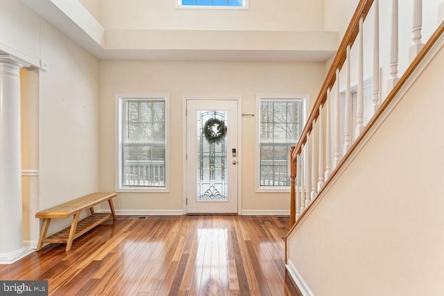 entrance foyer featuring ornate columns and hardwood / wood-style floors