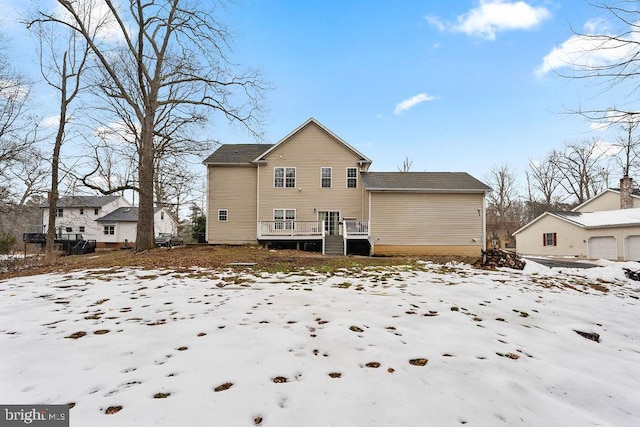 snow covered property with a wooden deck