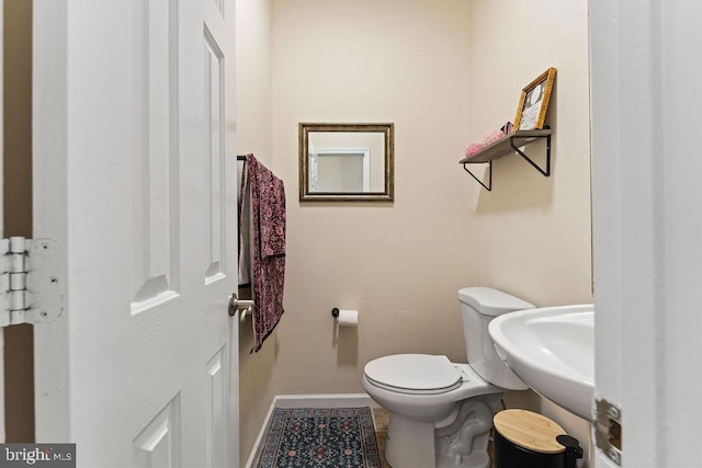 bathroom featuring sink and toilet