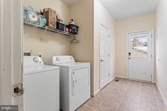 laundry area featuring independent washer and dryer and light tile patterned flooring