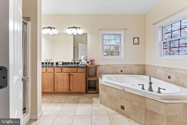 bathroom with vanity, tile patterned flooring, and plus walk in shower