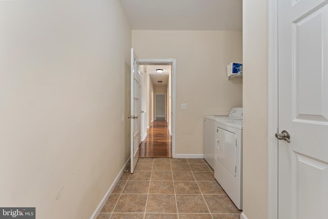 laundry area featuring independent washer and dryer, laundry area, and baseboards