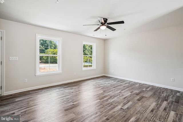 spare room featuring ceiling fan and dark wood-type flooring