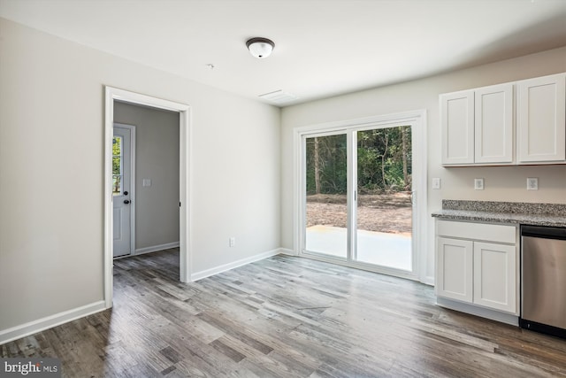 unfurnished dining area with hardwood / wood-style flooring and a wealth of natural light