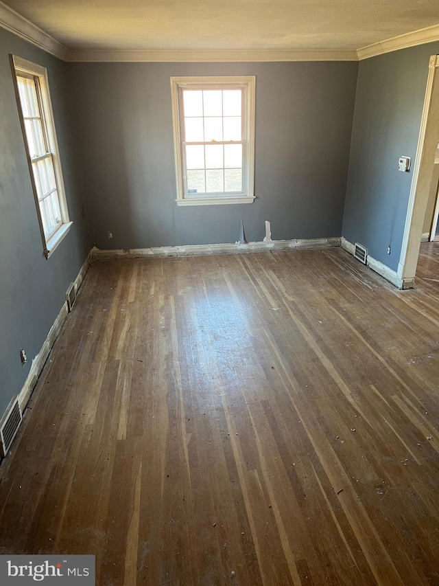 spare room with dark hardwood / wood-style flooring and ornamental molding