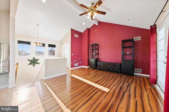 unfurnished living room with ceiling fan with notable chandelier, high vaulted ceiling, beam ceiling, and wood-type flooring