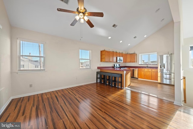 unfurnished living room with ceiling fan, light hardwood / wood-style floors, and a wealth of natural light