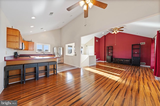 living room featuring sink, high vaulted ceiling, dark hardwood / wood-style flooring, and ceiling fan