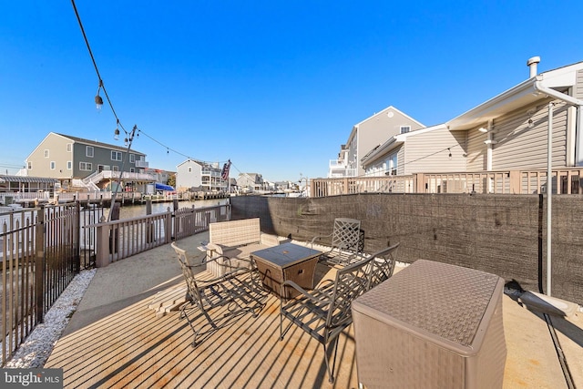 exterior space featuring an outdoor fire pit, a patio, and a water view