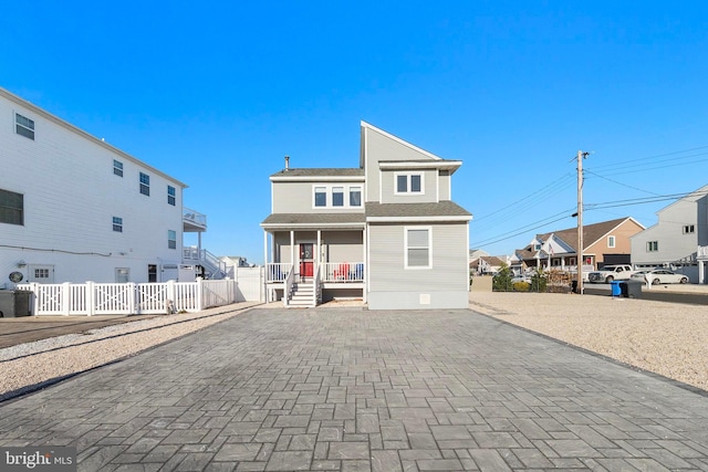 rear view of property featuring a porch