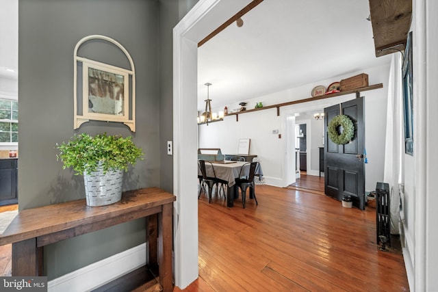 foyer with a chandelier and wood-type flooring