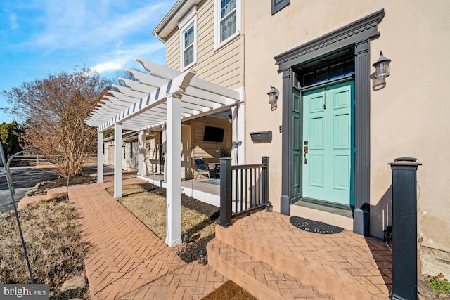 doorway to property with a pergola