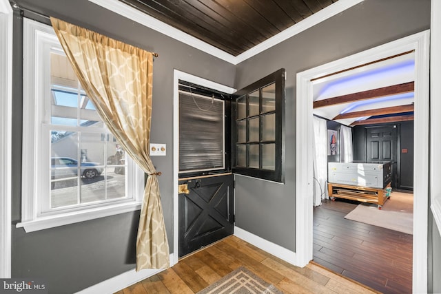 foyer with hardwood / wood-style flooring and crown molding