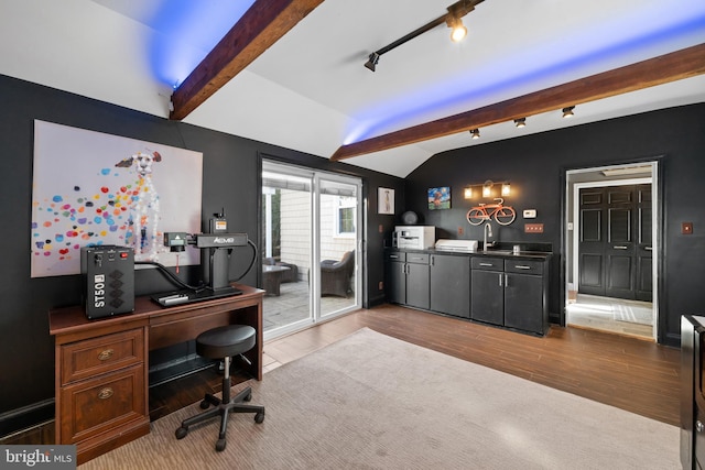 office featuring lofted ceiling, sink, and hardwood / wood-style floors