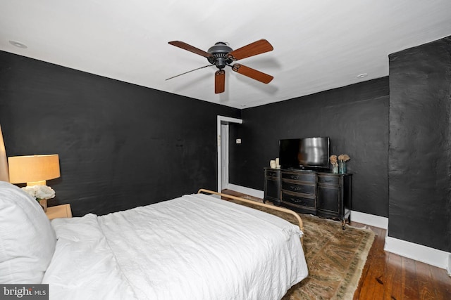 bedroom with ceiling fan and dark hardwood / wood-style floors