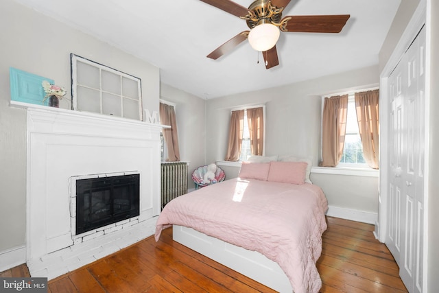 bedroom featuring ceiling fan, a closet, and hardwood / wood-style flooring